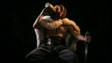 a viking in a white fur coat, drinking